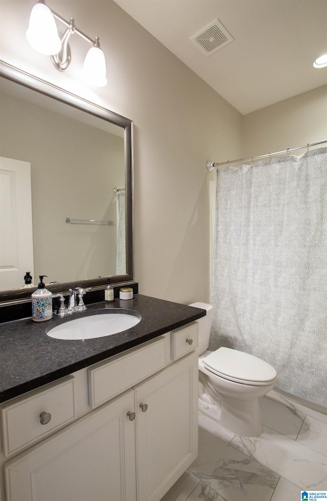 bathroom with vanity, a shower with shower curtain, and toilet