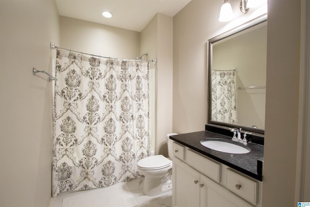 bathroom featuring vanity, a shower with shower curtain, and toilet