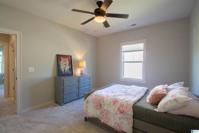 bedroom featuring ceiling fan and light carpet