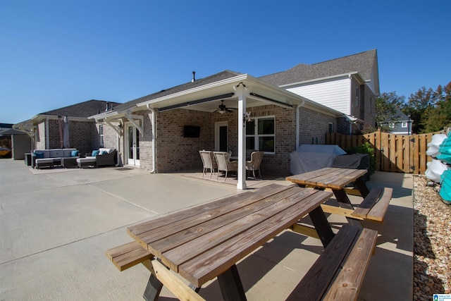 rear view of house with a patio area, an outdoor hangout area, and ceiling fan