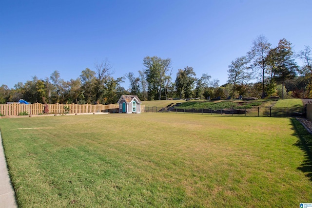 view of yard with a storage unit and a rural view