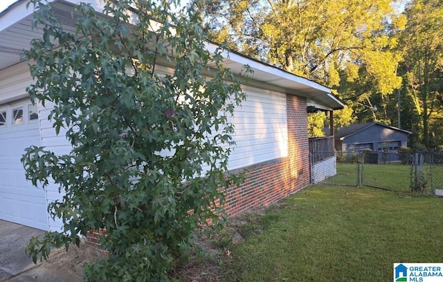 view of property exterior with a garage and a lawn