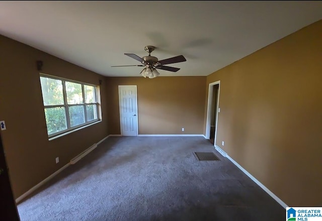 unfurnished bedroom featuring dark colored carpet and ceiling fan