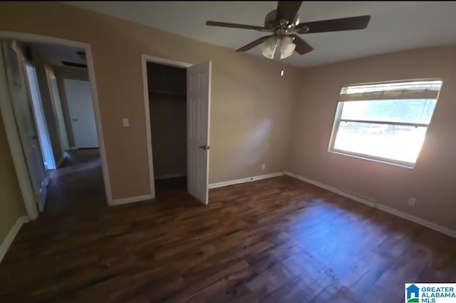 unfurnished bedroom featuring dark wood-type flooring and ceiling fan