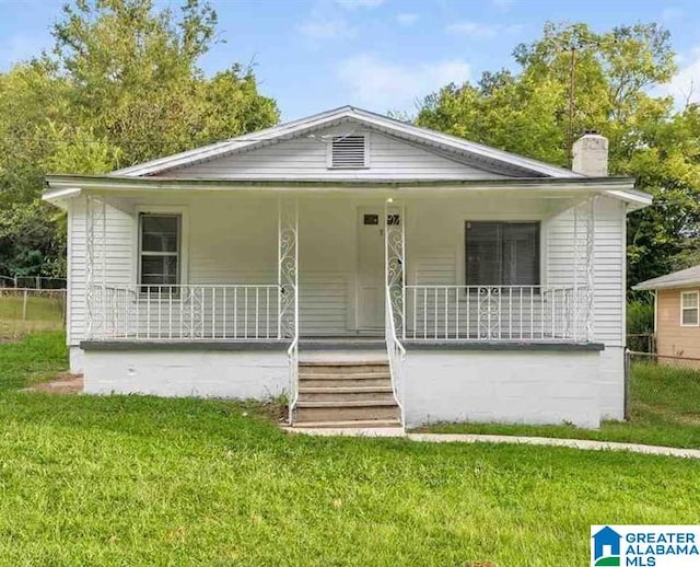 view of front of house with a front yard and a porch