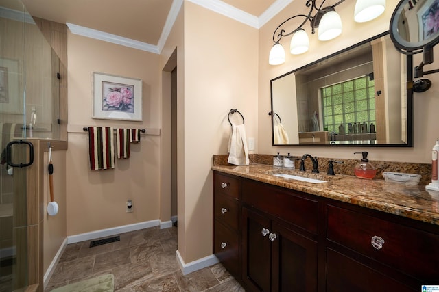 bathroom with vanity, crown molding, and a shower with shower door