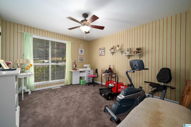 misc room featuring ceiling fan and dark colored carpet