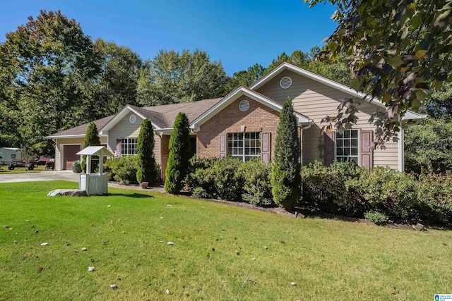 view of front of property featuring a front yard and a garage