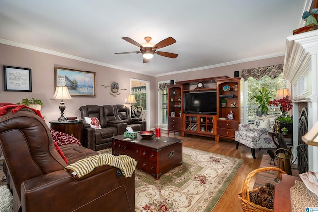 living room featuring crown molding, wood-type flooring, and ceiling fan