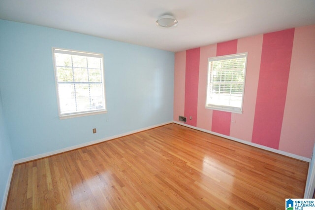 empty room featuring baseboards and wood finished floors
