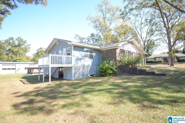 view of side of home with stairs, brick siding, a lawn, and a deck