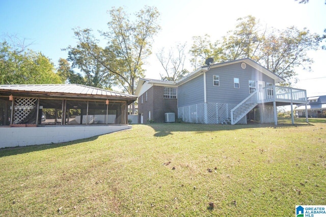 view of home's exterior with a deck, cooling unit, a sunroom, a yard, and stairway