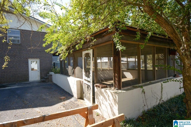 view of side of property with a sunroom