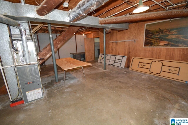 unfinished basement with heating unit and wood walls