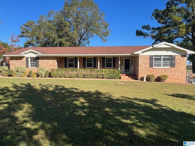 ranch-style home featuring a front yard