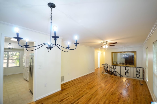 interior space with ceiling fan with notable chandelier, ornamental molding, and light wood-type flooring