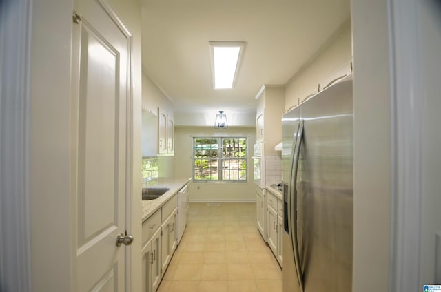 kitchen featuring white cabinetry, white appliances, light stone countertops, and backsplash