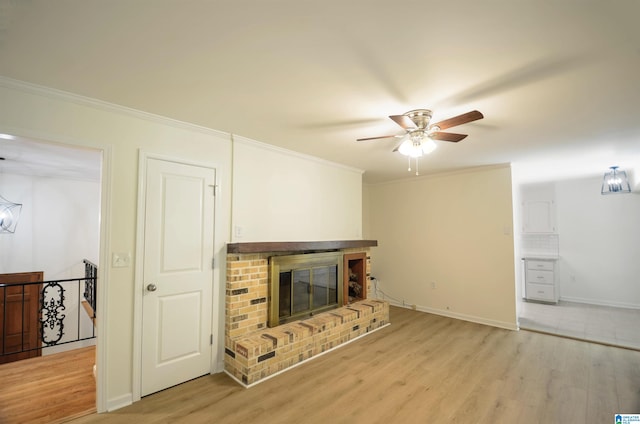 unfurnished living room with crown molding, a fireplace, and light hardwood / wood-style flooring