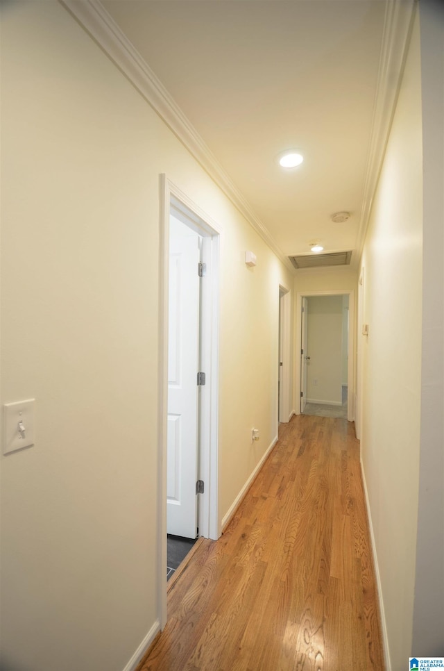 hall featuring ornamental molding and light hardwood / wood-style flooring