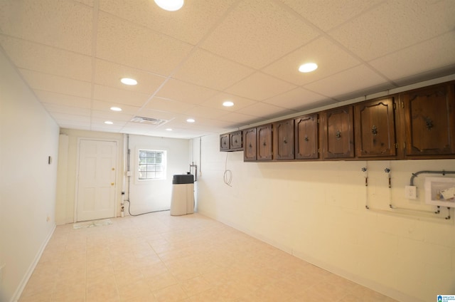 basement with a paneled ceiling