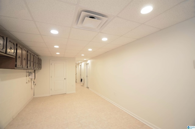 basement with a paneled ceiling