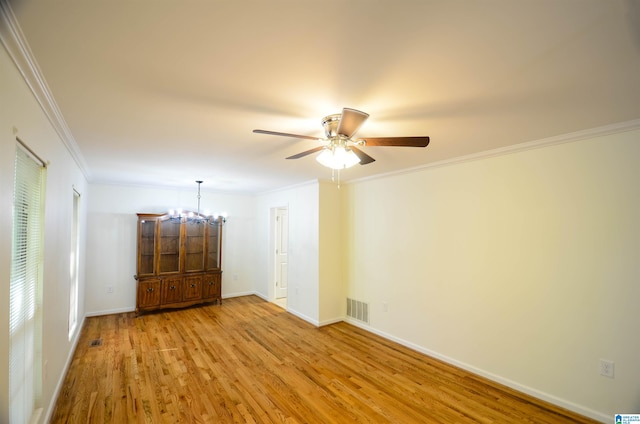 spare room featuring crown molding, ceiling fan with notable chandelier, and light hardwood / wood-style flooring