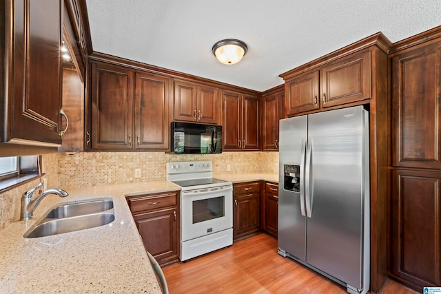 kitchen featuring backsplash, stainless steel fridge with ice dispenser, light wood-type flooring, white range with electric cooktop, and sink