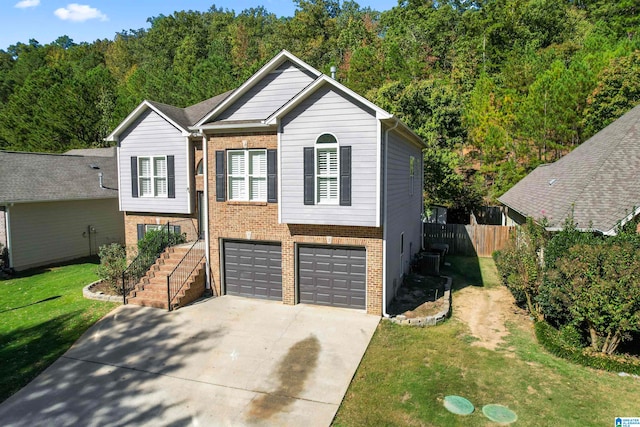 view of front of property featuring a front lawn and a garage