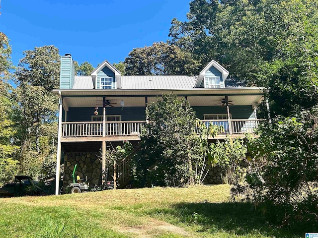 view of front of property with metal roof, ceiling fan, and a chimney