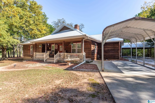 view of front of property featuring a carport and a porch