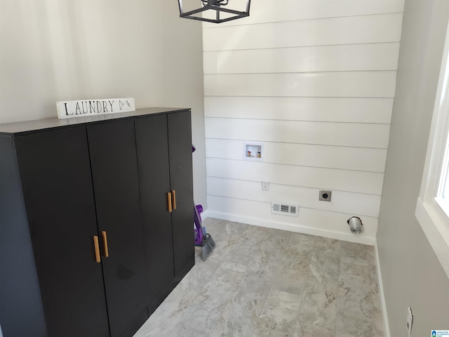 washroom featuring electric dryer hookup, washer hookup, and cabinets