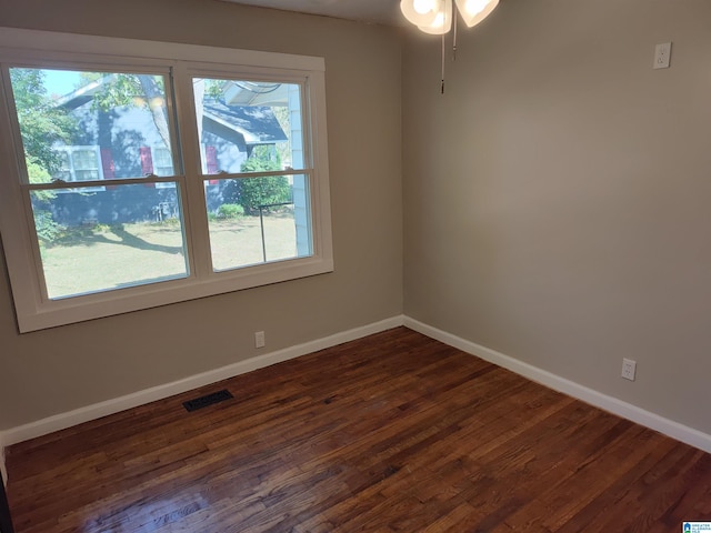 spare room with ceiling fan and dark hardwood / wood-style flooring