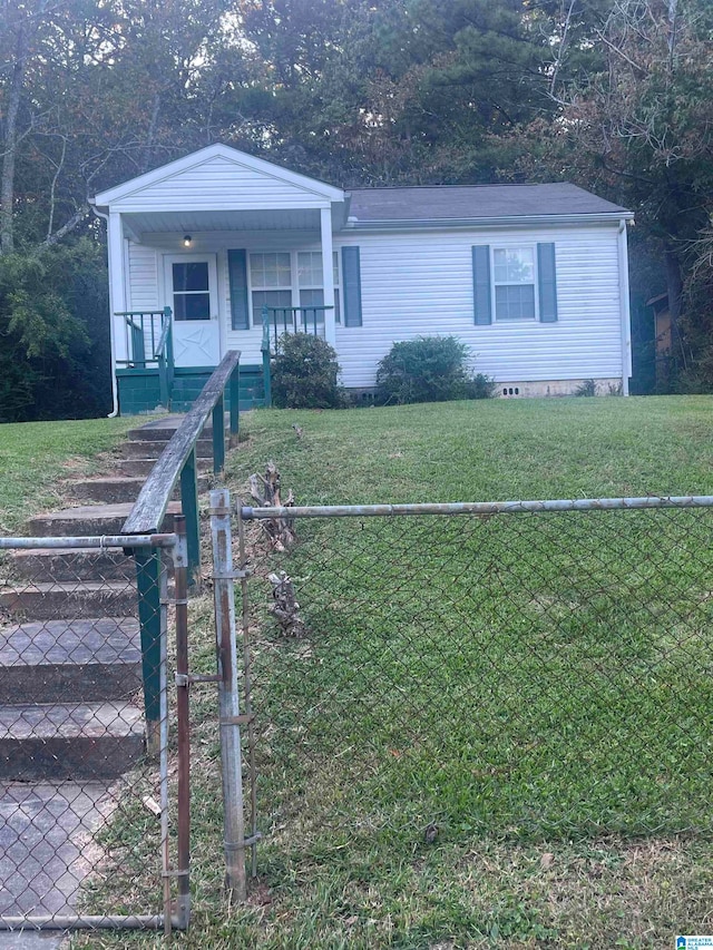 view of front of home featuring a front yard and covered porch