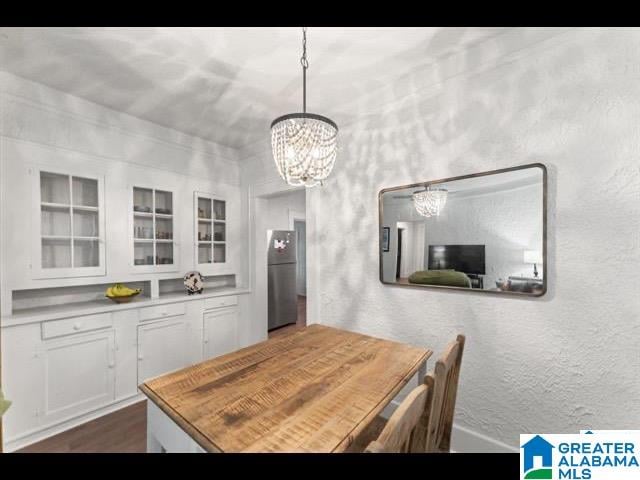 dining area with a chandelier and dark hardwood / wood-style flooring