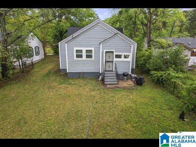 back of house with a lawn