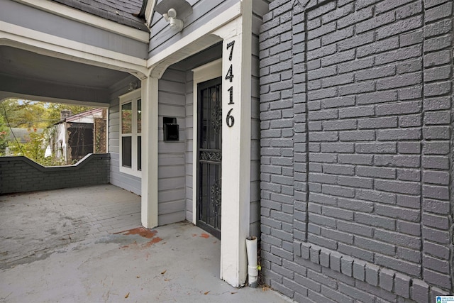 property entrance featuring brick siding