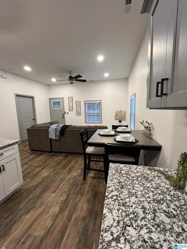 dining space featuring ceiling fan and dark hardwood / wood-style flooring