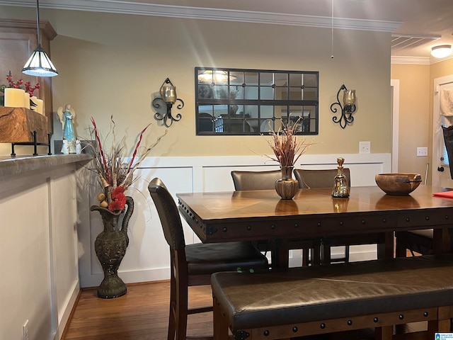 dining area with ornamental molding and wood-type flooring