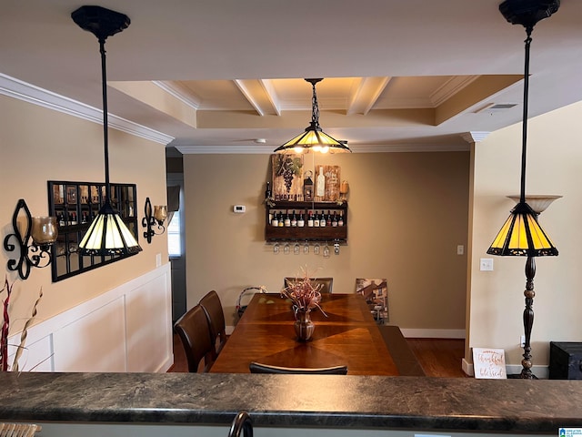 dining space featuring crown molding, hardwood / wood-style flooring, and beam ceiling