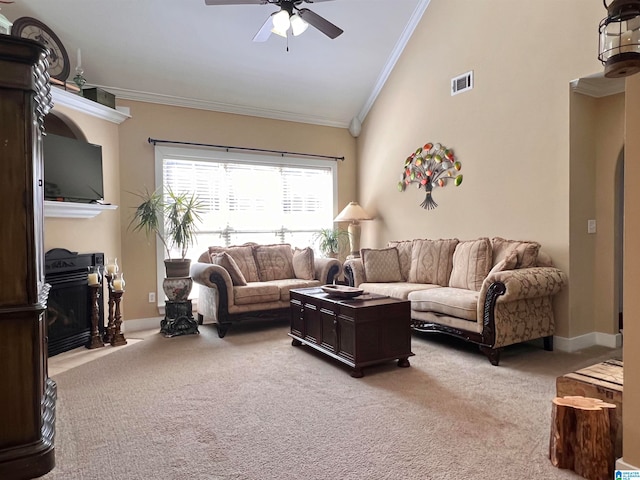 carpeted living room featuring crown molding, high vaulted ceiling, and ceiling fan