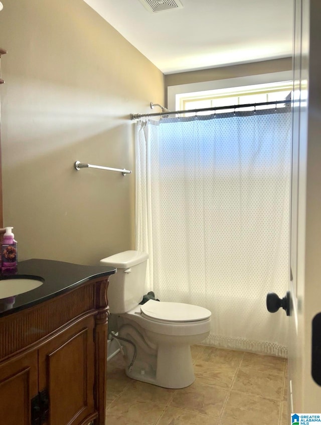 bathroom featuring vanity, toilet, tile patterned floors, and a shower with curtain