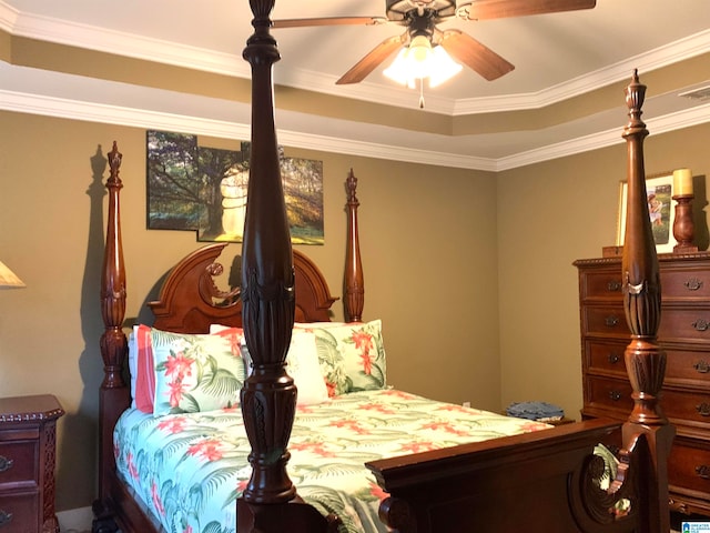 bedroom featuring ceiling fan, crown molding, and a tray ceiling