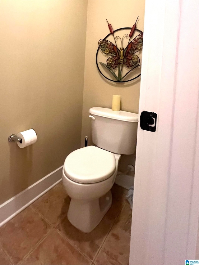 bathroom with toilet and tile patterned floors