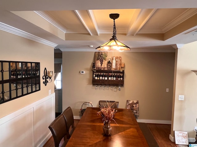 dining area featuring beam ceiling, ornamental molding, and dark wood-type flooring