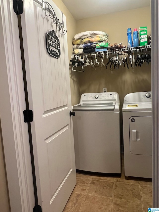 washroom with separate washer and dryer and tile patterned flooring