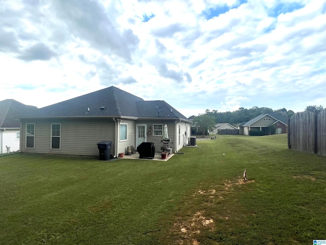 rear view of house with a patio area, central AC, and a lawn