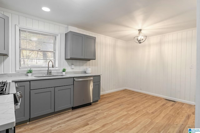 kitchen with gray cabinets, stainless steel dishwasher, sink, and light wood-type flooring