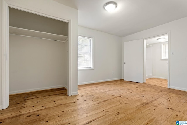 unfurnished bedroom featuring a closet and light hardwood / wood-style floors