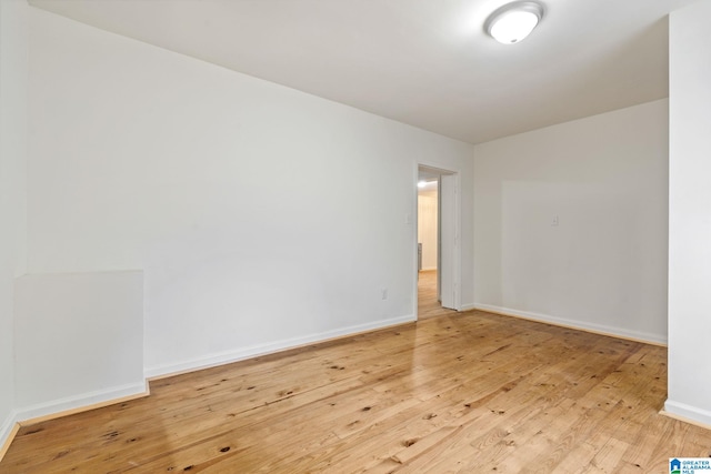 unfurnished room with hardwood / wood-style floors