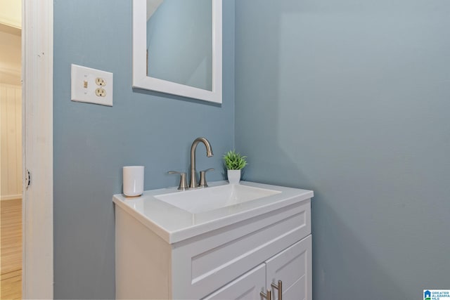 bathroom with vanity and hardwood / wood-style flooring